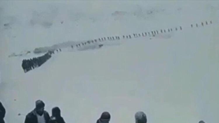  Karda tek sıra halinde yürüyen göçmenlerle ilgili açıklama