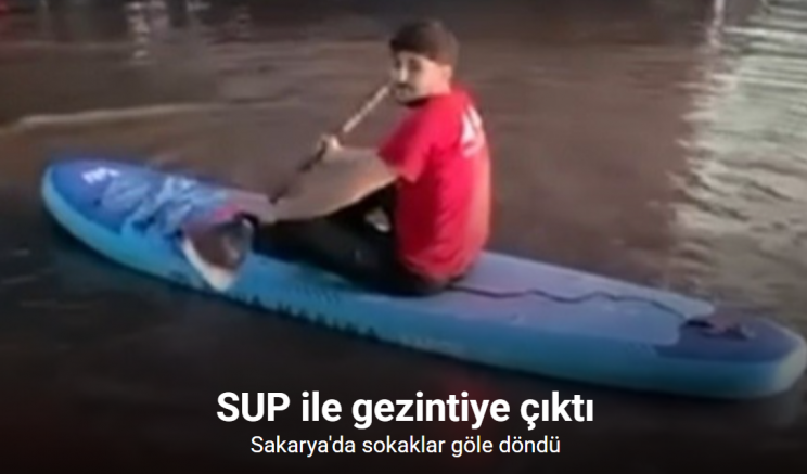 Sokaklar göle dönünce SUP ile gezintiye çıktı