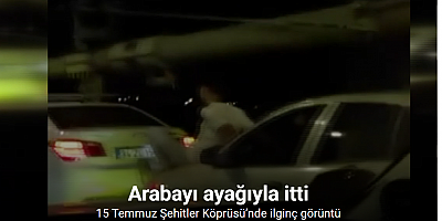 15 Temmuz Şehitler Köprüsü’nde ilginç görüntü: Aracın kaputuna oturdu, önündeki arabayı ayağıyla itti