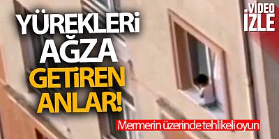 Camdan çıkarak mermerin üzerinde oturan çocuğun tehlikeli oyunu kamerada