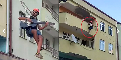 Eşyalarını taşıdığı halatın üzerinde gitar çalıp, şarkı söyledi