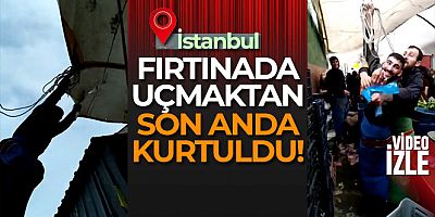 Fırtınada çadırını bağlarken uçma tehlikesi yaşayan pazarcı kamerada
