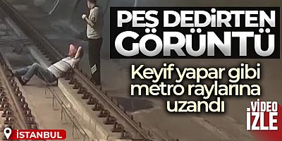 Keyif yapar gibi metro raylarına uzandı