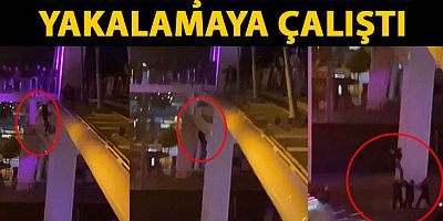 Üst geçitten atlayan kadını aşağıdakiler yakalamaya çalıştı