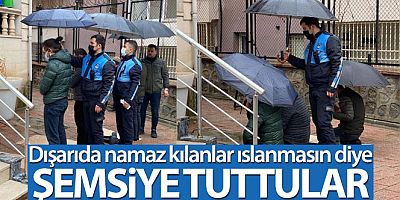 Zabıtalar dışarıda namaz kılanlar ıslanmasın diye şemsiye tuttu